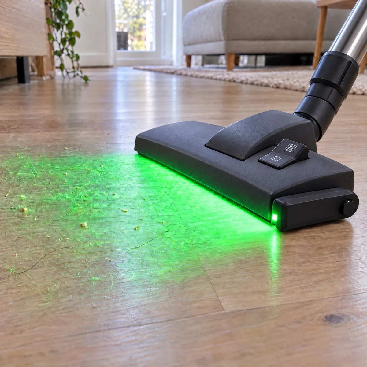 DustLight on a vacuum, its green light shows dust on the floor